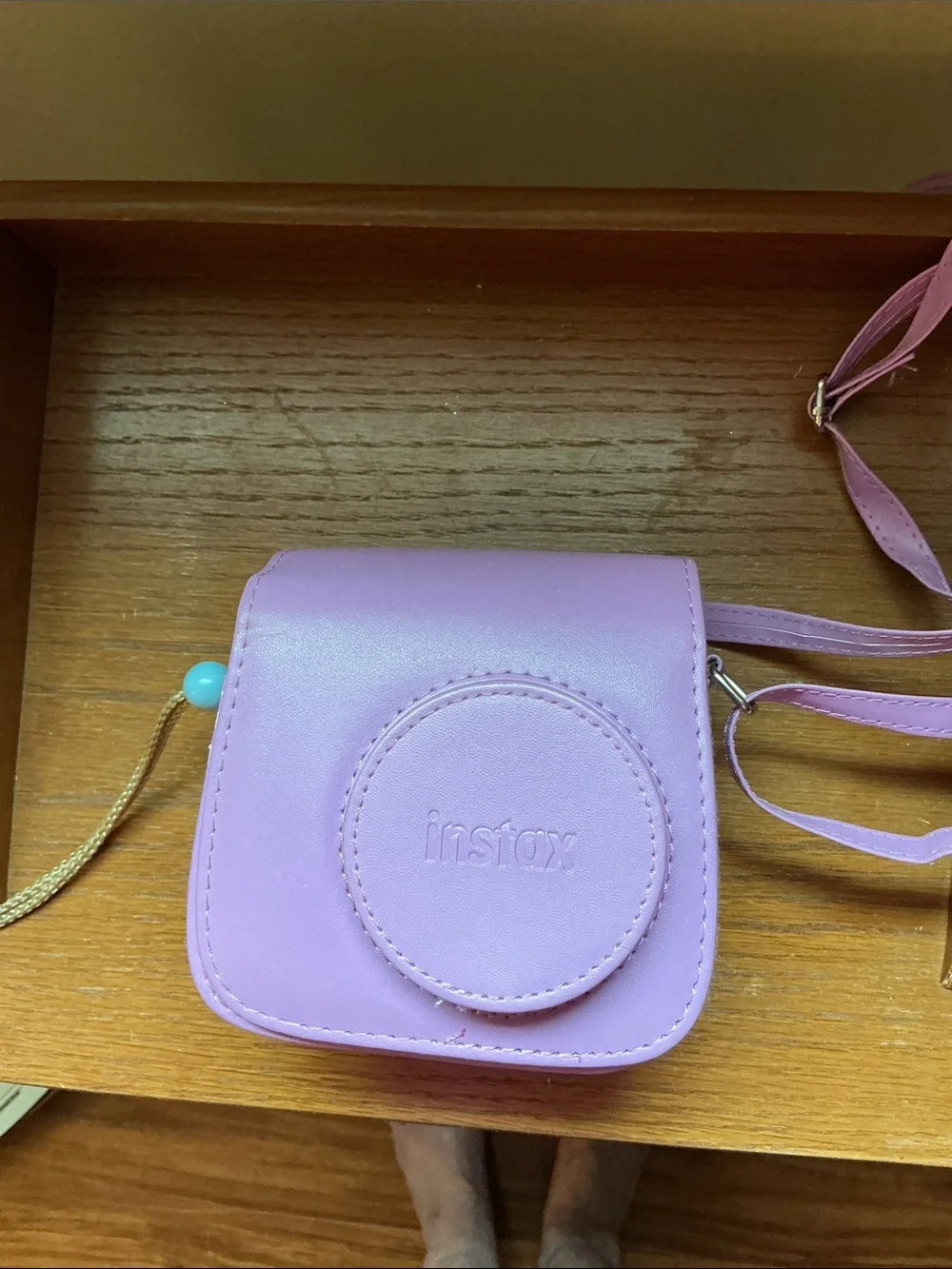 Instax Mini instant camera in light blue with pink carrying case